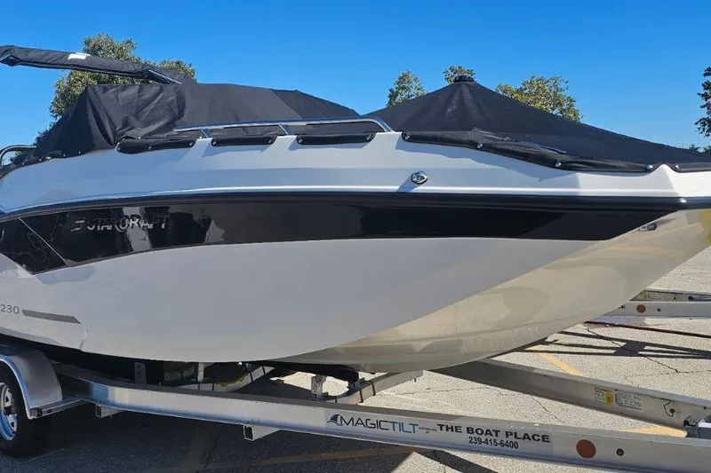 Slide: The Image of 2026 Starcraft SVX 230 DC OB boat on trailer, covered and ready for transport. - 4