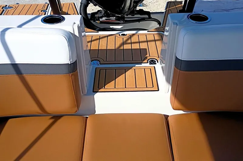 Slide: The Image of 2026 Starcraft SVX 230 DC OB boat interior with tan seating and wood flooring. - 41