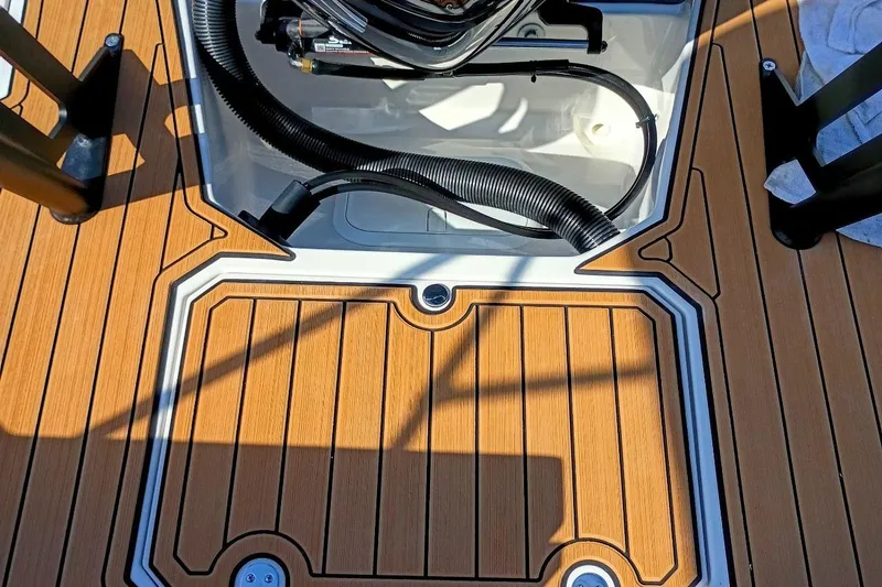 Slide: The Image of Deck of 2026 Starcraft SVX 230 DC OB boat with wood finish and storage compartment. - 42