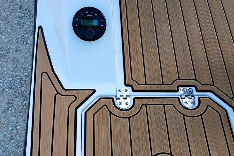 Slide: The Image of 2026 Starcraft SVX 230 DC OB boat deck with wood finish and control panel. - 48