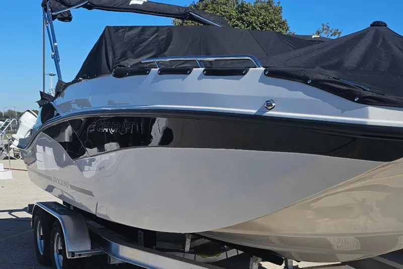 Slide: The Image of 2026 Starcraft SVX 230 DC OB boat on trailer, covered and ready for transport. - 7