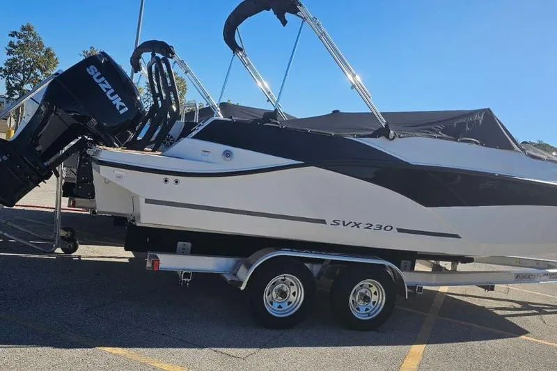 Slide: The Image of 2026 Starcraft SVX 230 DC OB boat on trailer with Suzuki outboard motor. - 8