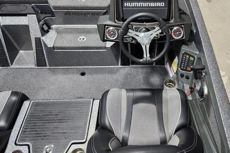Slide: The Image of 2022 Ranger Z519 boat interior with steering wheel, Humminbird display, and seating. - 3
