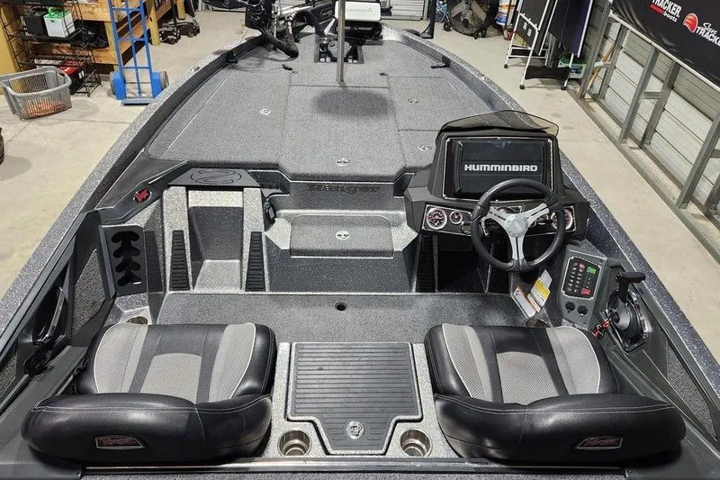 Slide: The Image of 2022 Ranger Z519 boat interior with dual seats, steering wheel, and Humminbird navigation system. - 4