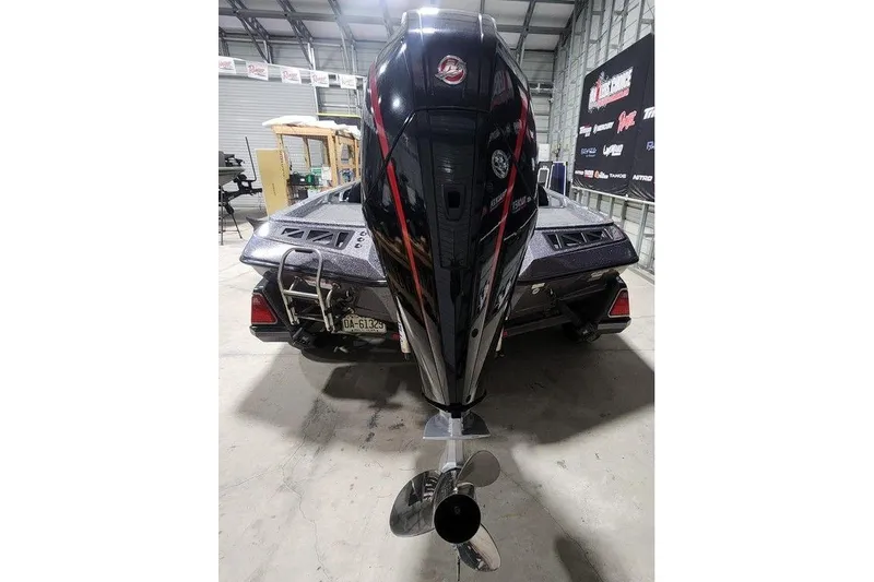 Slide: The Image of 2022 Ranger Z519 boat with powerful outboard motor in a garage setting. - 5