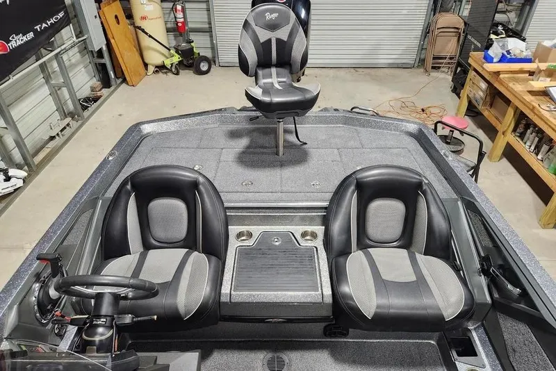 Slide: The Image of 2022 Ranger Z519 boat interior with three seats in a garage setting. - 6