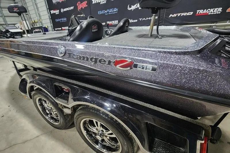 Slide: The Image of 2022 Ranger Z519 boat with metallic finish, displayed indoors on a trailer. - 7