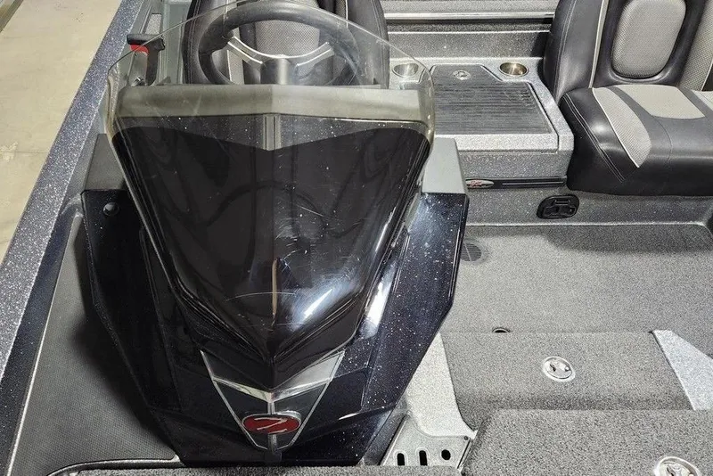 Slide: The Image of 2022 Ranger Z519 boat interior with steering wheel and seating area. - 9