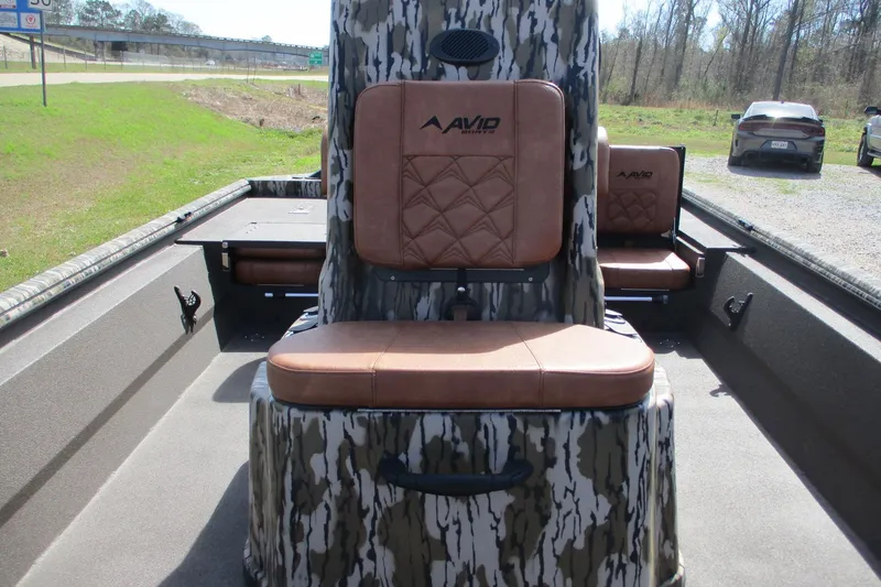 Slide: The Image of 2026 Avid 20 Rogue CC boat interior with camo design and brown seating. - 10