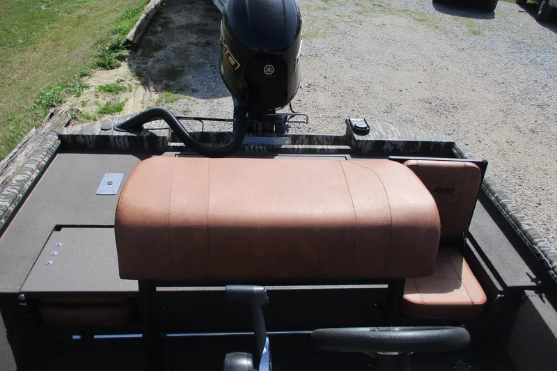 Slide: The Image of 2026 Avid 20 Rogue CC boat interior with brown seating and motor. - 13