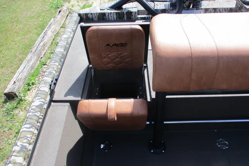 Slide: The Image of 2026 Avid 20 Rogue CC boat interior with brown leather seats and camouflage trim. - 14