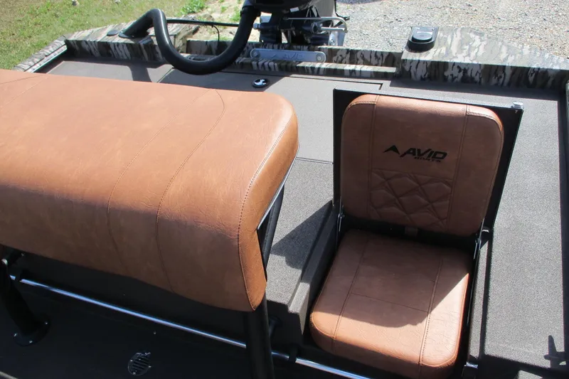 Slide: The Image of 2026 Avid 20 Rogue CC boat seats with brown leather upholstery and logo. - 15