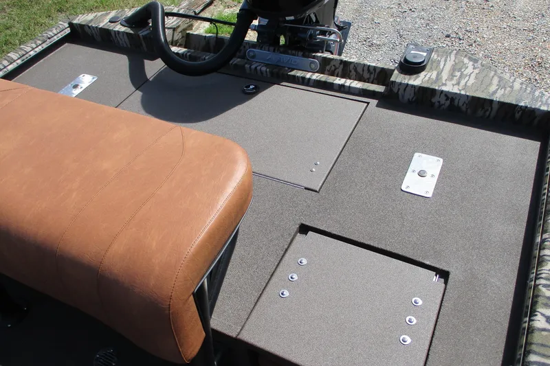 Slide: The Image of Avid 20 Rogue CC 2026 boat interior with brown seat and storage compartments. - 16