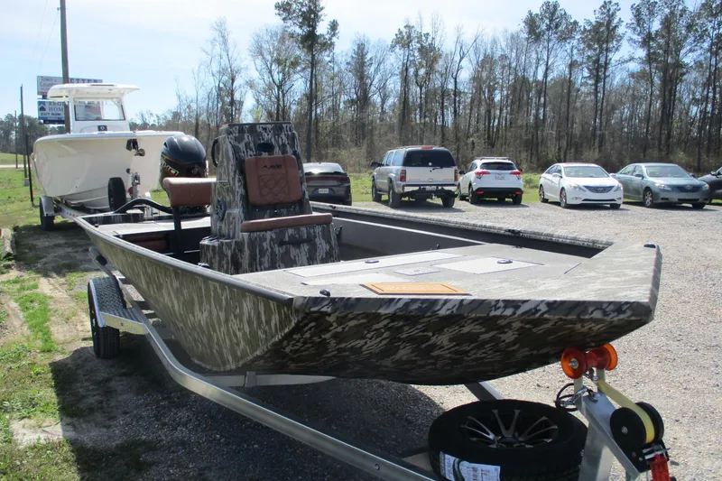 Slide: The Image of 2026 Avid 20 Rogue CC boat on trailer, parked outdoors with cars in background. - 3