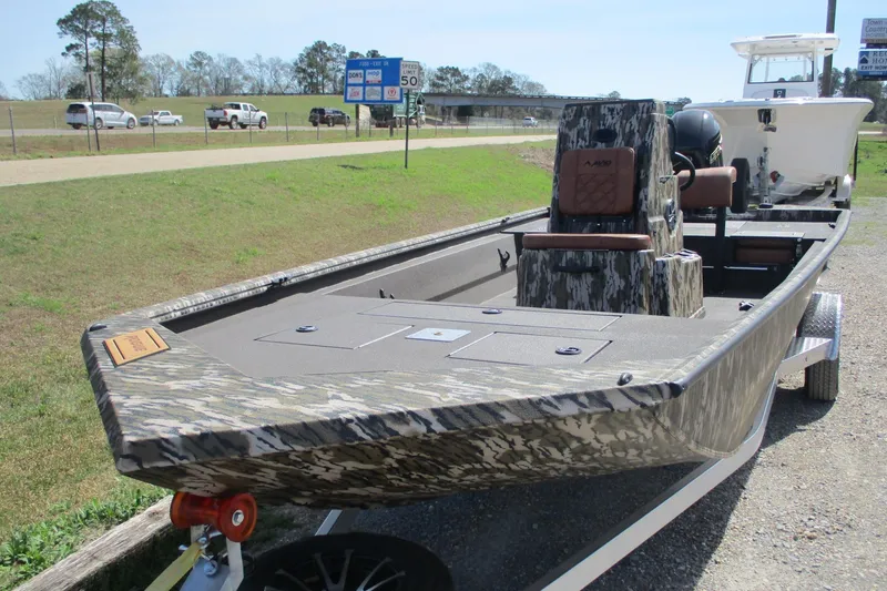 Slide: The Image of 2026 Avid 20 Rogue CC boat with camouflage design on a trailer. - 4