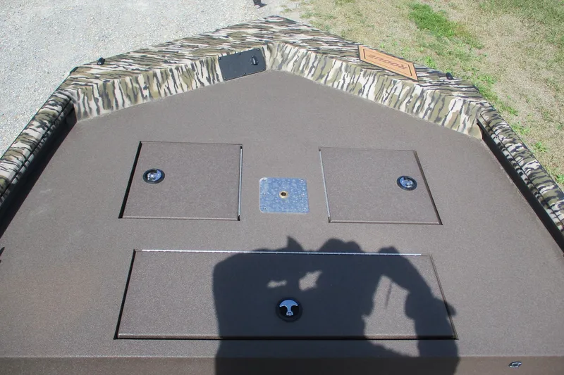 Slide: The Image of 2026 Avid 20 Rogue CC boat deck with camo trim and storage compartments. - 8