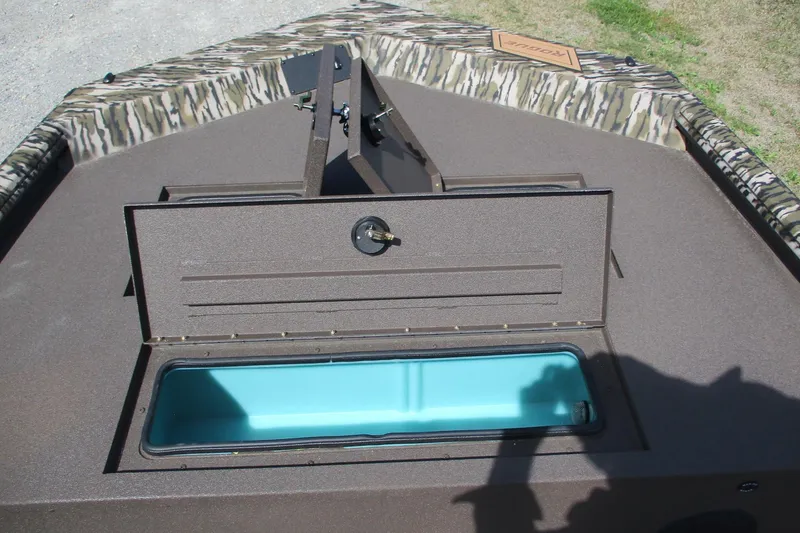 Slide: The Image of 2026 Avid 20 Rogue CC boat with open storage compartment and camouflage trim. - 9