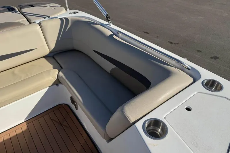 Slide: The Image of 2018 Hurricane SunDeck Sport 188 IO boat interior with beige seating and cup holders. - 12