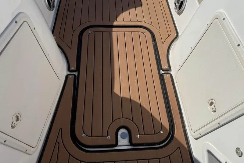 Slide: The Image of 2018 Hurricane SunDeck Sport 188 IO boat deck with brown and black detailing. - 15