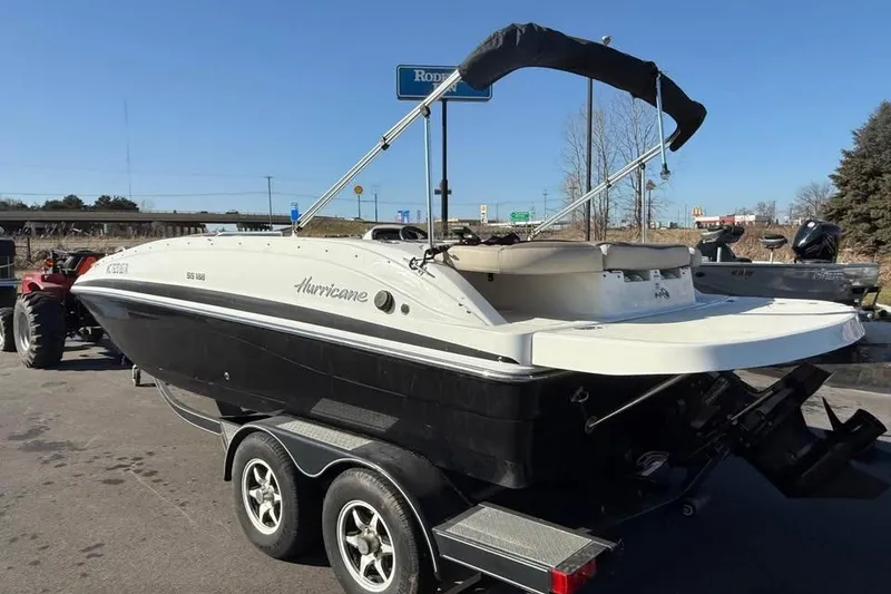 Slide: The Image of 2018 Hurricane SunDeck Sport 188 IO boat on trailer, parked outdoors. - 3
