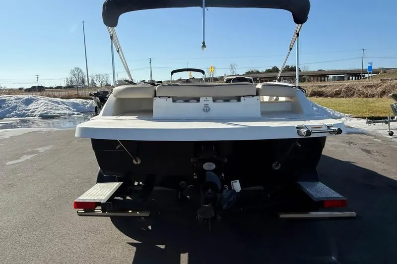 Slide: The Image of 2018 Hurricane SunDeck Sport 188 IO boat, rear view, parked outdoors on a sunny day. - 5