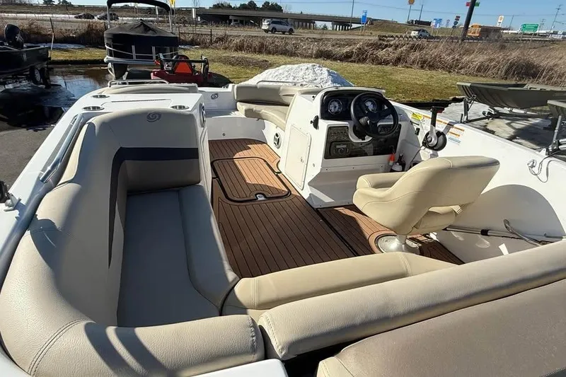 Slide: The Image of 2018 Hurricane SunDeck Sport 188 IO boat interior with beige seating and wood flooring. - 6