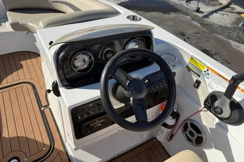 Slide: The Image of 2018 Hurricane SunDeck Sport 188 IO boat dashboard with steering wheel and controls. - 9