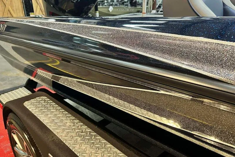 Slide: The Image of 2023 Triton 20 TrX Patriot boat with sleek, metallic finish on trailer. - 17