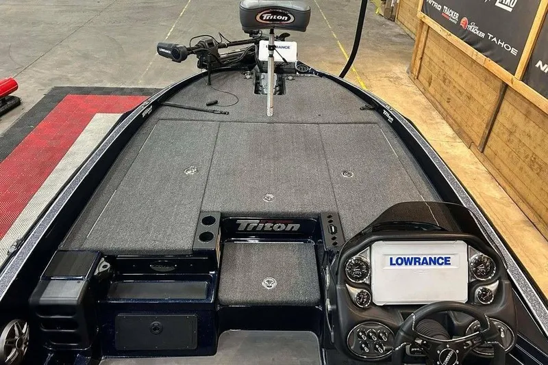 Slide: The Image of 2023 Triton 20 TrX Patriot boat interior with Lowrance electronics and steering console. - 4