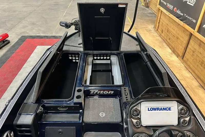 Slide: The Image of 2023 Triton 20 TrX Patriot boat interior with storage compartments and Lowrance electronics. - 5