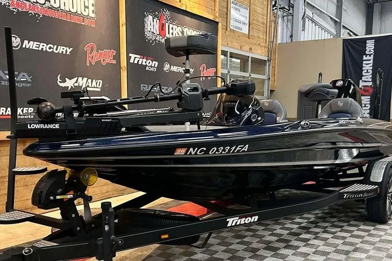 Slide: The Image of 2023 Triton 20 TrX Patriot boat displayed indoors on a trailer. - 8