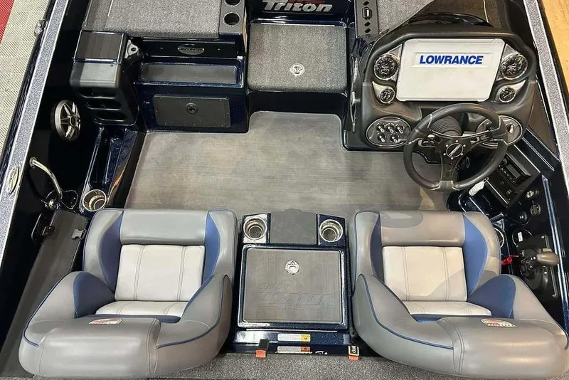 Slide: The Image of 2023 Triton 20 TrX Patriot boat interior with dual seats, steering wheel, and Lowrance display. - 9