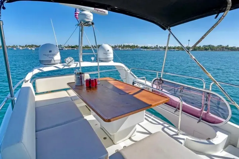 Slide: The Image of Flybridge of 2013 Azimut 45 yacht with seating and table, overlooking blue ocean waters. - 11