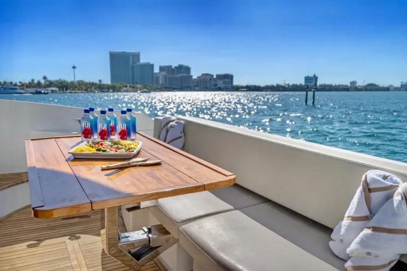 Slide: The Image of Luxurious 2013 Azimut 45 yacht with dining setup, overlooking sparkling waterfront cityscape. - 12