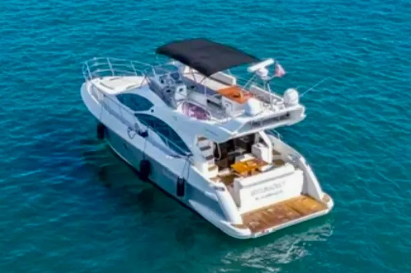 Slide: The Image of 2013 Azimut 45 yacht on clear blue water, featuring a spacious deck and modern design. - 5