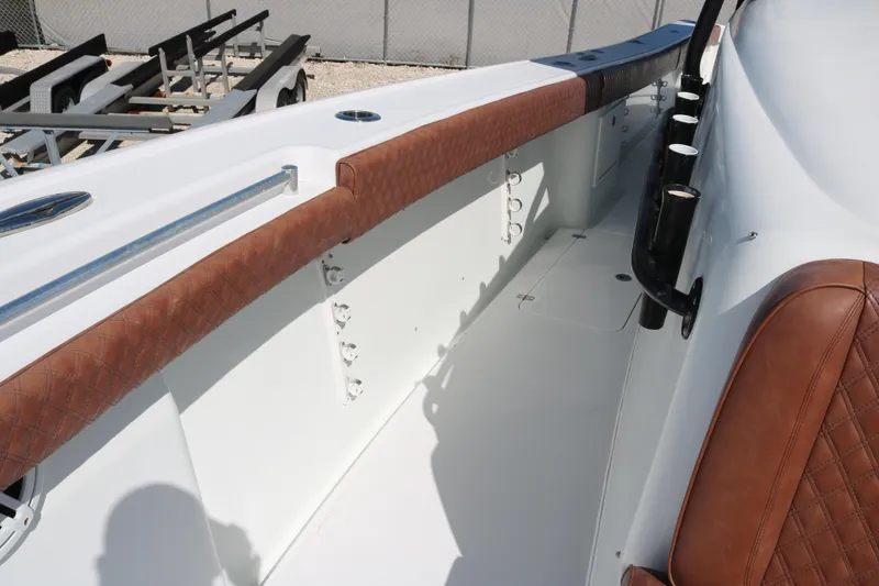 Slide: The Image of 2008 Yellowfin 42 Offshore boat interior with brown leather accents and rod holders. - 10