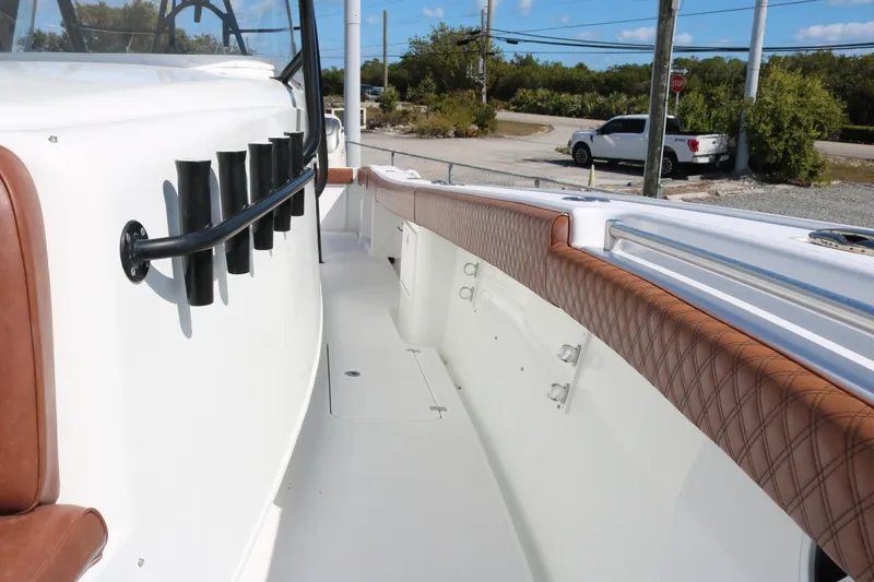 Slide: The Image of 2008 Yellowfin 42 Offshore boat deck with rod holders and cushioned seating. - 11