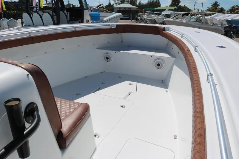 Slide: The Image of 2008 Yellowfin 42 Offshore boat interior with brown seating and white deck. - 12