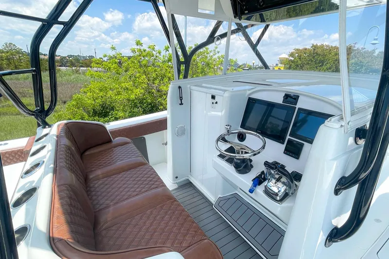 Slide: The Image of 2008 Yellowfin 42 Offshore boat interior with leather seating and modern control panel. - 13