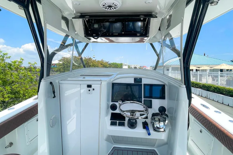 Slide: The Image of 2008 Yellowfin 42 Offshore boat helm with modern controls and steering wheel. - 14