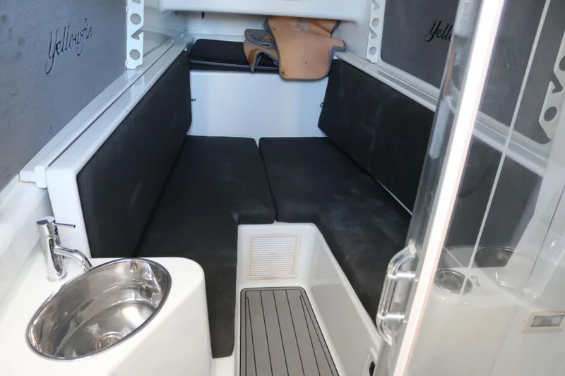Slide: The Image of 2008 Yellowfin 42 Offshore cabin interior with seating and sink. - 17
