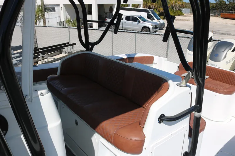 Slide: The Image of 2008 Yellowfin 42 Offshore boat interior with brown leather seating and Suzuki engines. - 22
