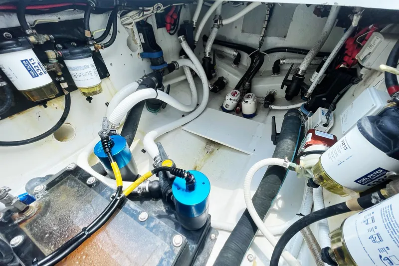 Slide: The Image of Engine compartment of a 2008 Yellowfin 42 Offshore boat, showcasing fuel filters and hoses. - 27