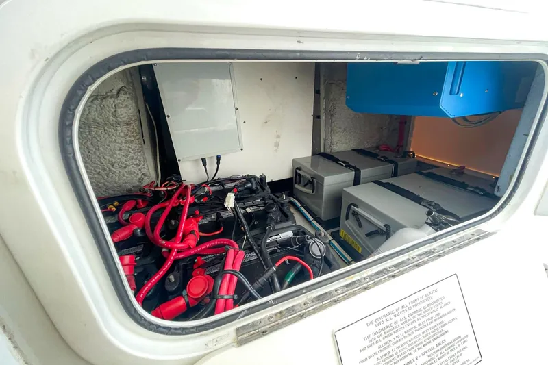 Slide: The Image of Electrical compartment of 2008 Yellowfin 42 Offshore boat with batteries and wiring. - 29