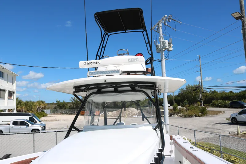 Slide: The Image of 2008 Yellowfin 42 Offshore boat with Garmin radar, docked under clear blue sky. - 5