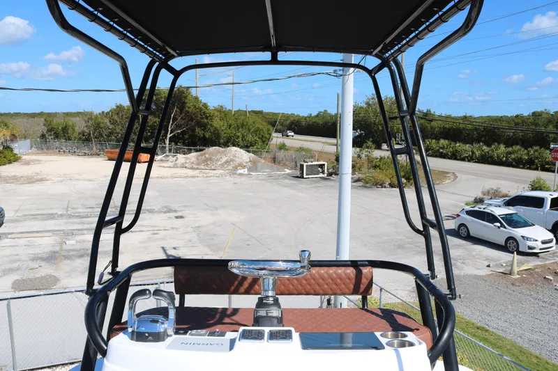 Slide: The Image of 2008 Yellowfin 42 Offshore boat helm with Garmin equipment, parked near a road. - 7