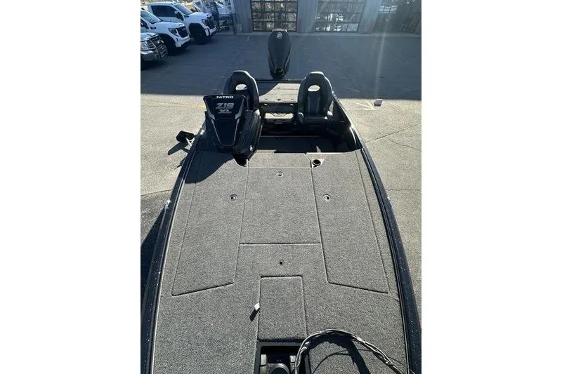 Slide: The Image of 2026 Nitro Z19 XL Pro boat, spacious deck, dual seats, outdoor setting. - 9