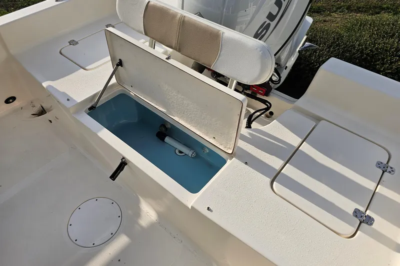 Slide: The Image of 2024 Bulls Bay 2200 boat interior with open storage compartment and seating. - 10