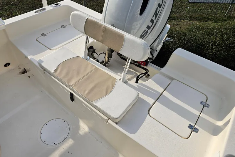 Slide: The Image of 2024 Bulls Bay 2200 boat interior with seating and Suzuki outboard motor. - 12