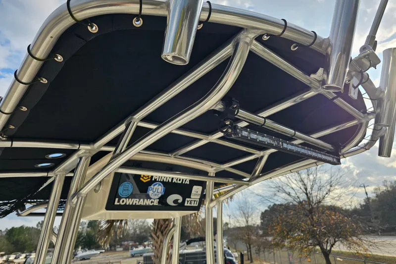 Slide: The Image of 2024 Bulls Bay 2200 boat T-top with rod holders and mounted accessories. - 14